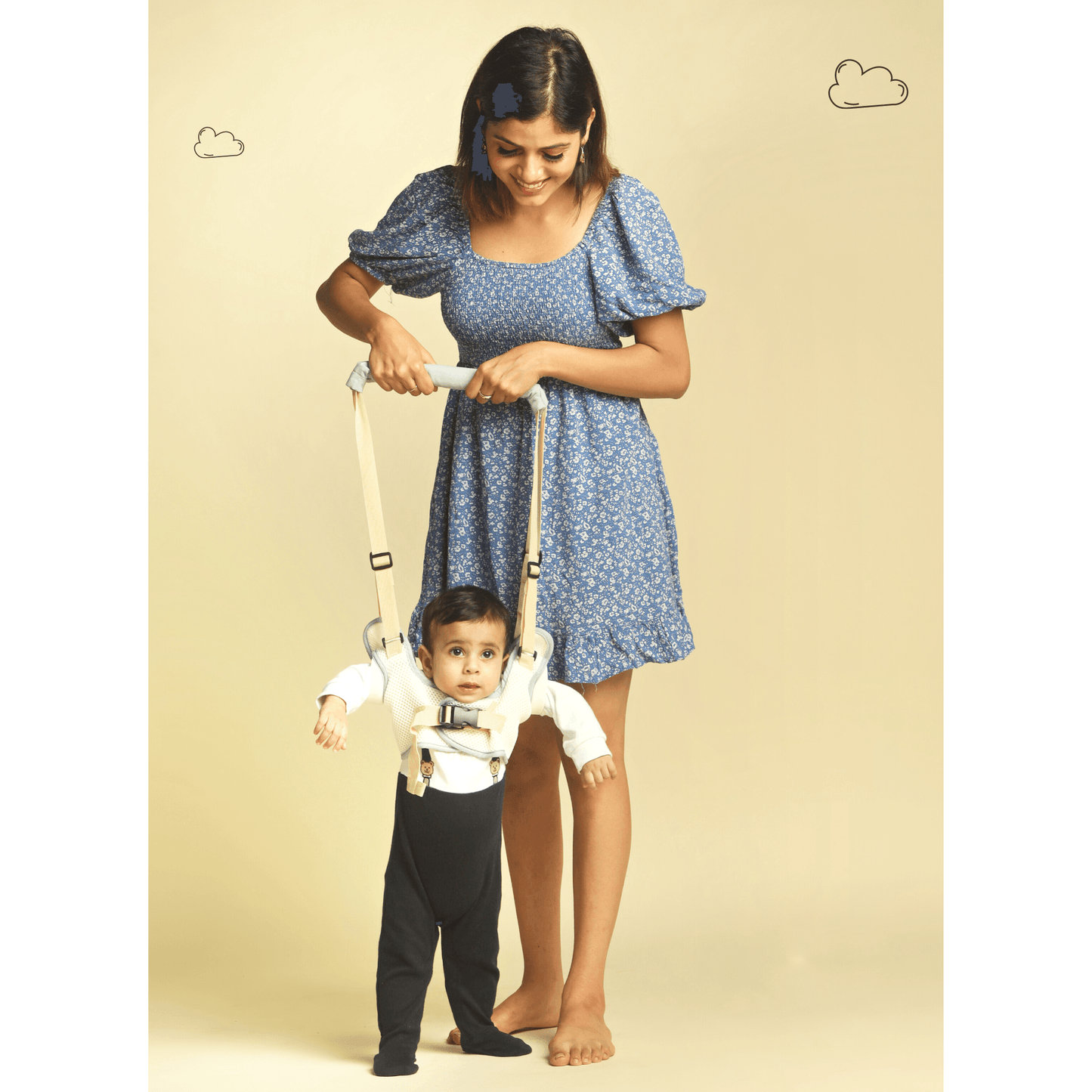 mother teaching baby to walk with walking harness for child