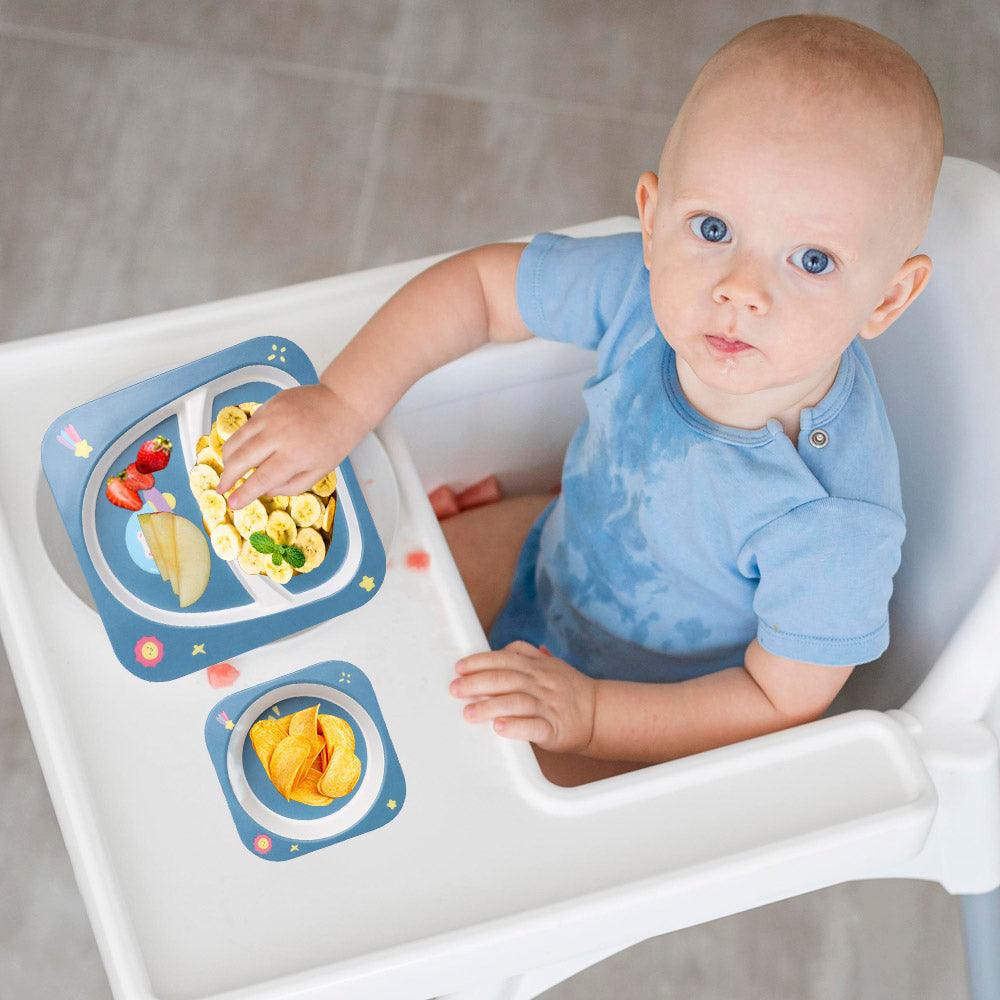 baby eating food in polka tots dinner set