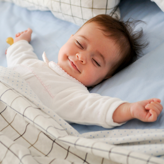 newborn sleeping peacefully using blanket 
