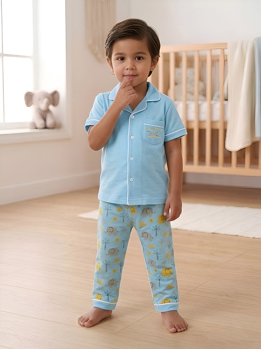 Child wearing a light blue pajama set with animal prints in a nursery.