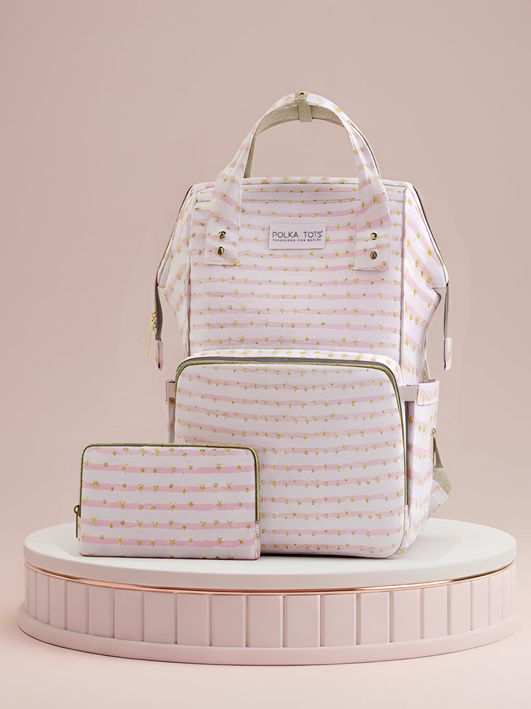 Set of bags including a backpack and a pouch with a striped pattern on a pink background