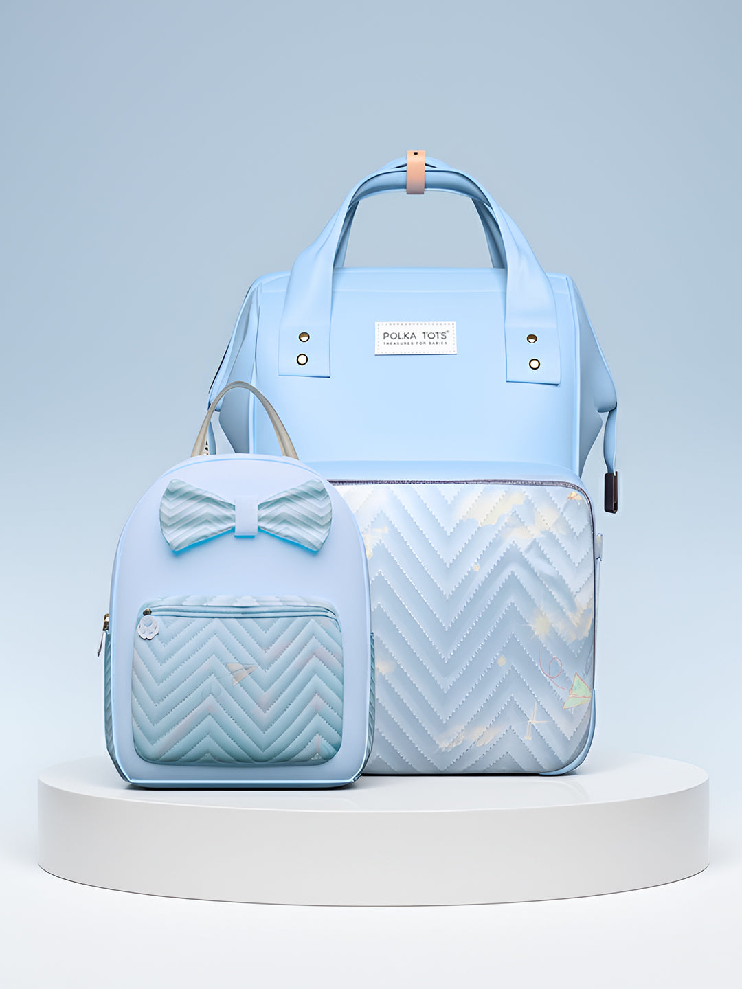 Light blue diaper bag with a bow and chevron pattern on a gray background