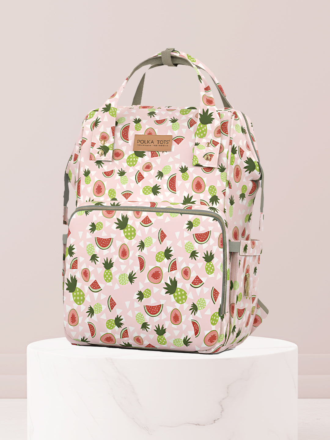 Backpack with watermelon and pineapple pattern on a light gray background