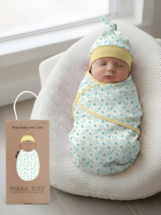 Newborn baby swaddled in a patterned blanket with a matching hat, next to a Polka Tots product card.