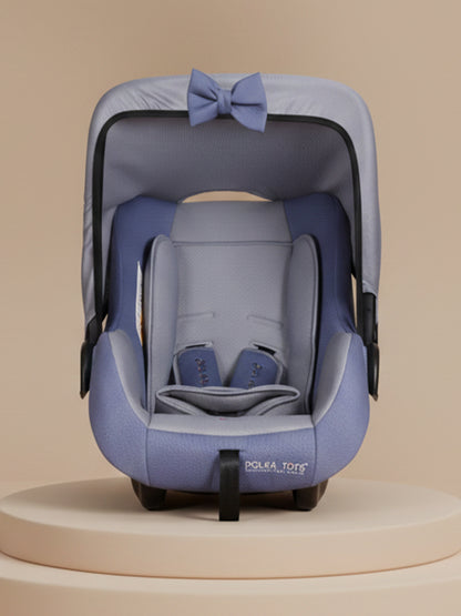 Blue baby car seat with a bow on a beige background