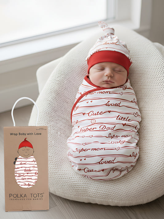 Newborn baby swaddled in a red and white patterned blanket with a matching hat, next to a Polka Tots product packaging.
