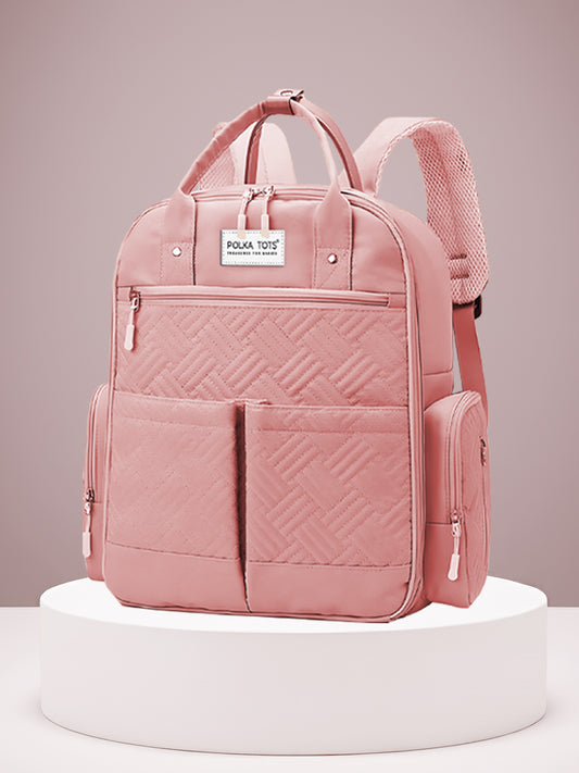 Pink backpack with a geometric pattern on a white platform against a light pink background