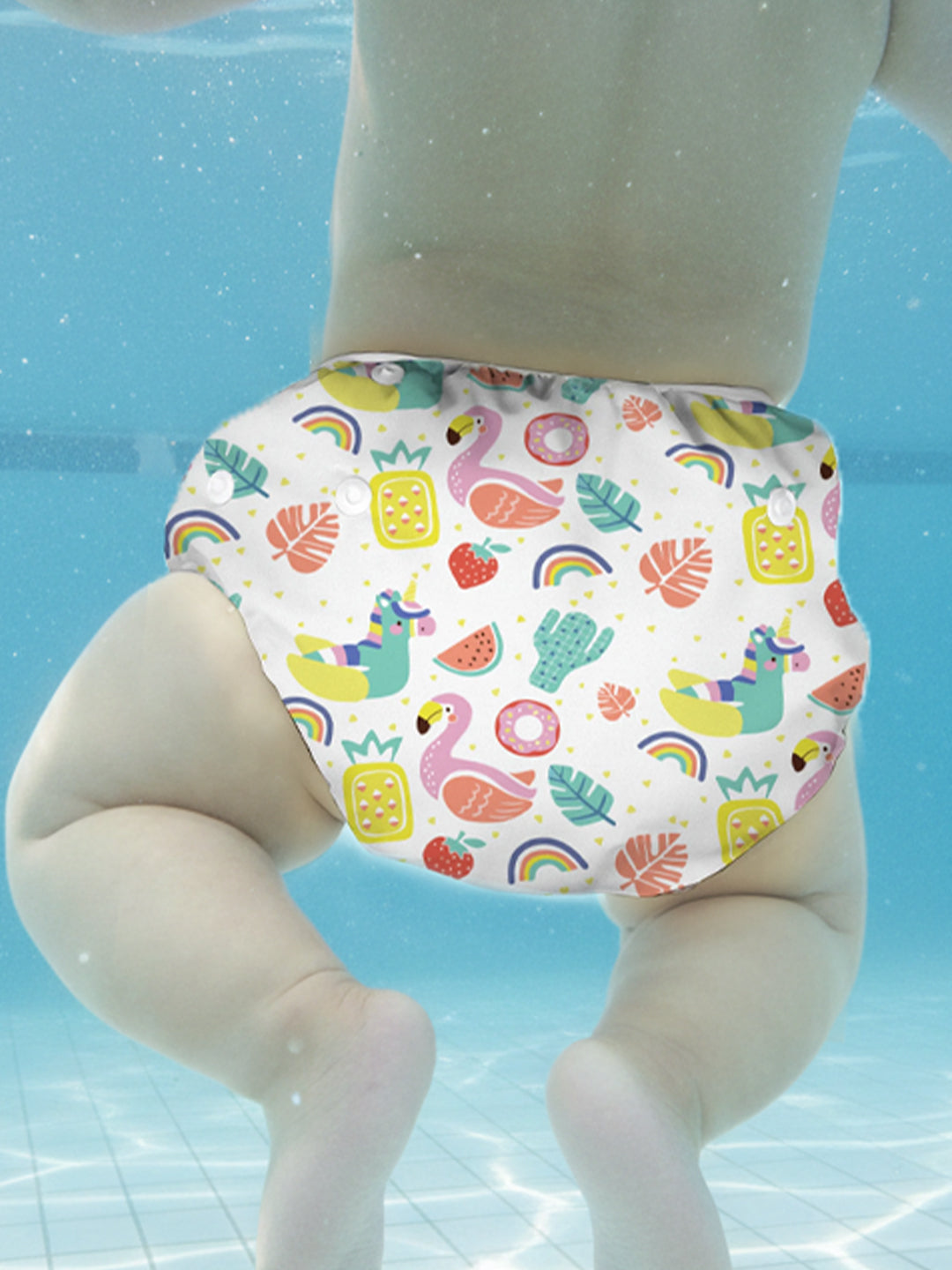 Colorful swim diaper with cartoon designs on a toy figure against a water background