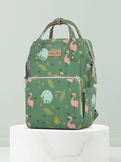 Green backpack with flamingo and elephant pattern on a light gray background