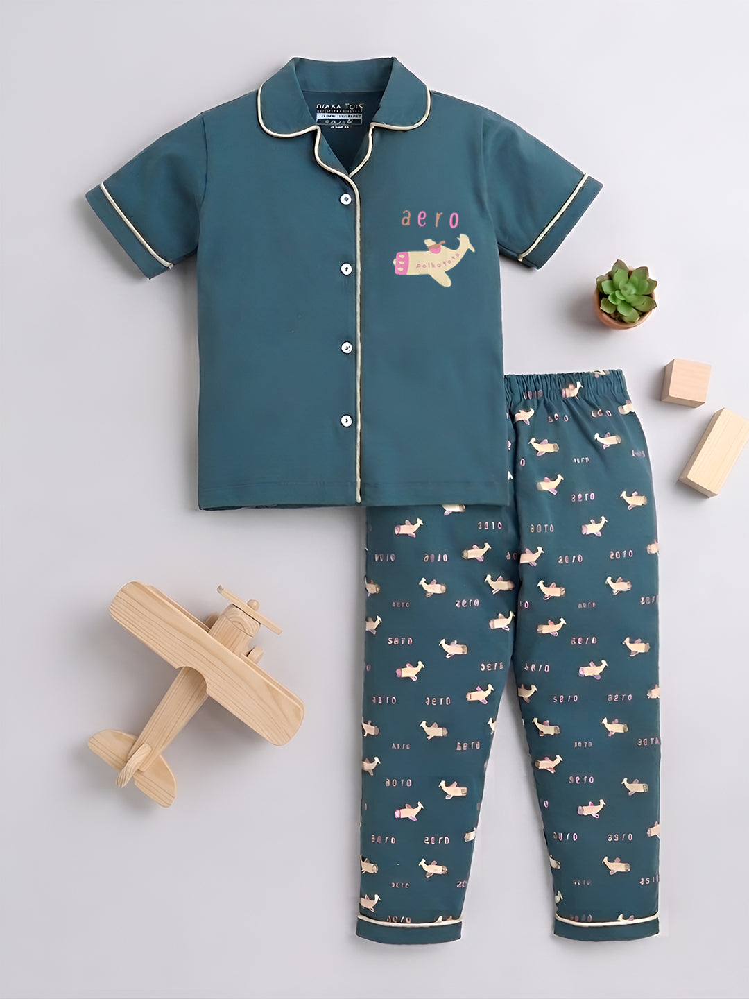 Children's pajama set with airplane design on a light gray background