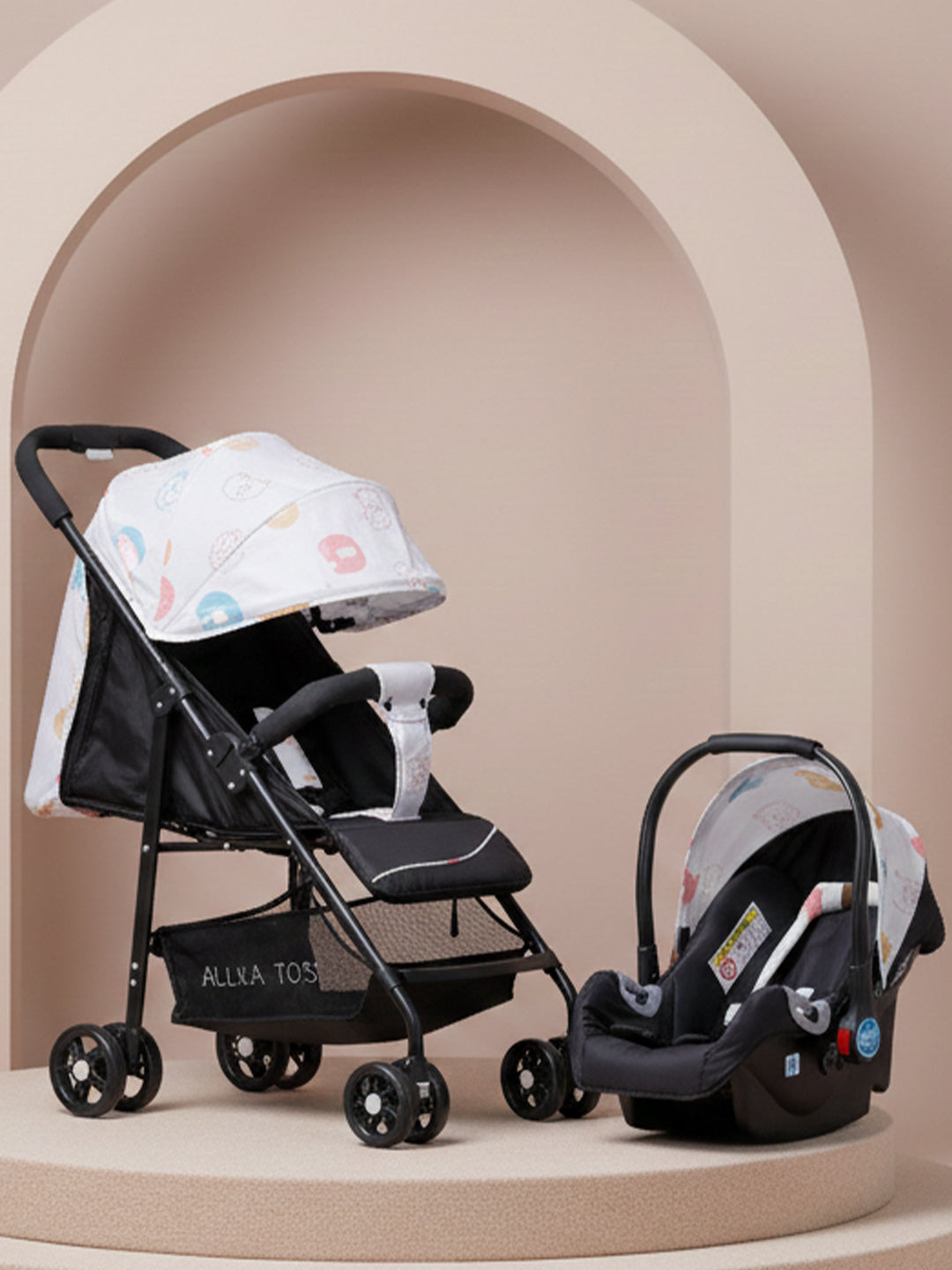 Black stroller and car seat with floral canopy on a beige background