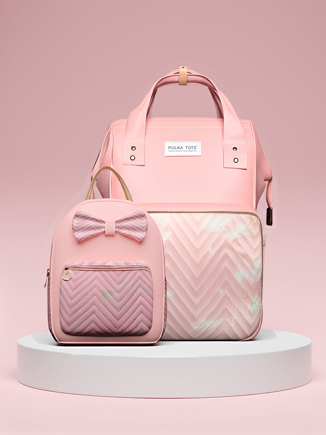 Pink backpack with bow detail and chevron pattern on a pink background