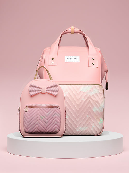 Pink backpack with bow detail and chevron pattern on a pink background