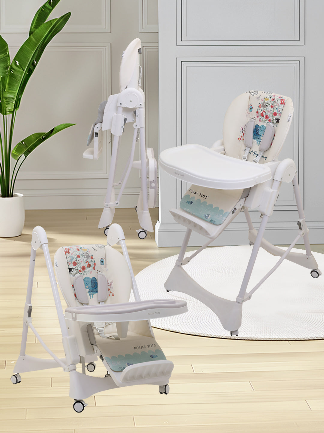 White baby high chair with floral pattern on a wooden floor.