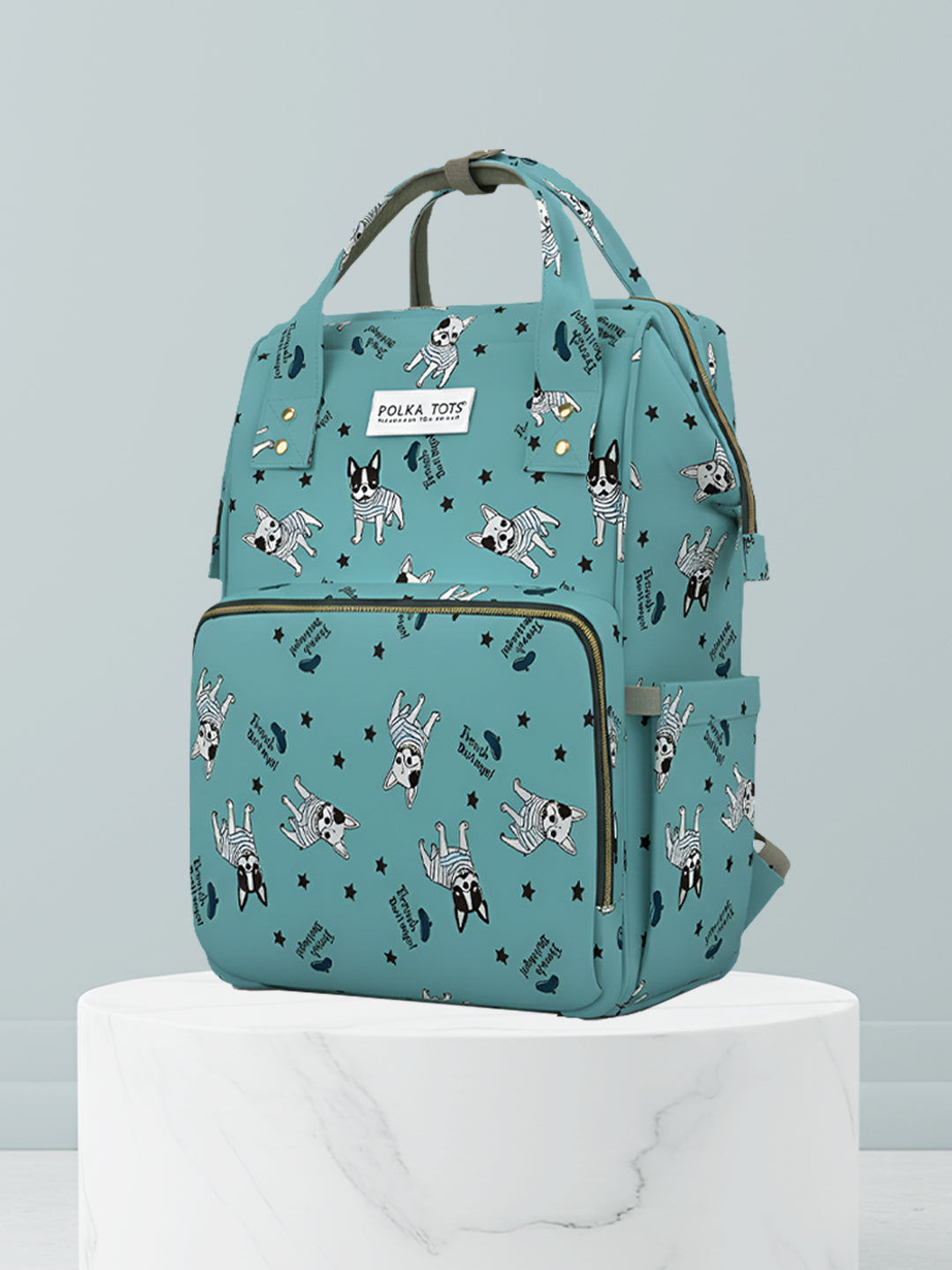 Teal backpack with dog pattern on a light gray background