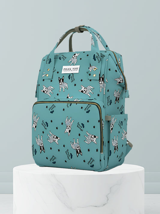 Teal backpack with dog pattern on a light gray background