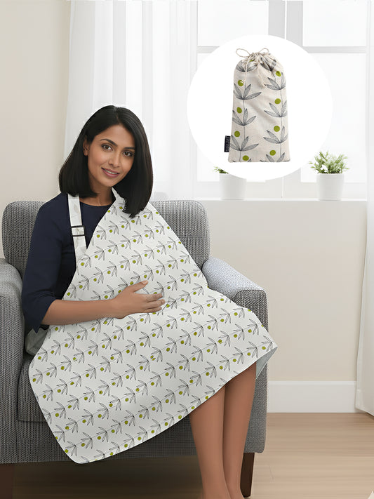 Woman sitting on a chair wearing a patterned apron with a matching bag in the background.