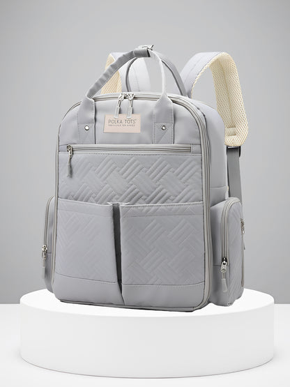 Gray backpack with quilted design on a white platform against a gray background