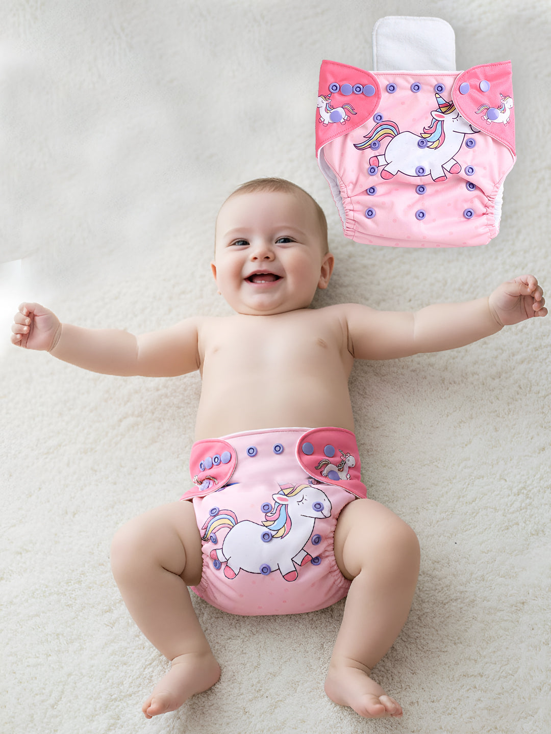 Baby wearing pink unicorn-patterned diaper with a matching bag on a light background