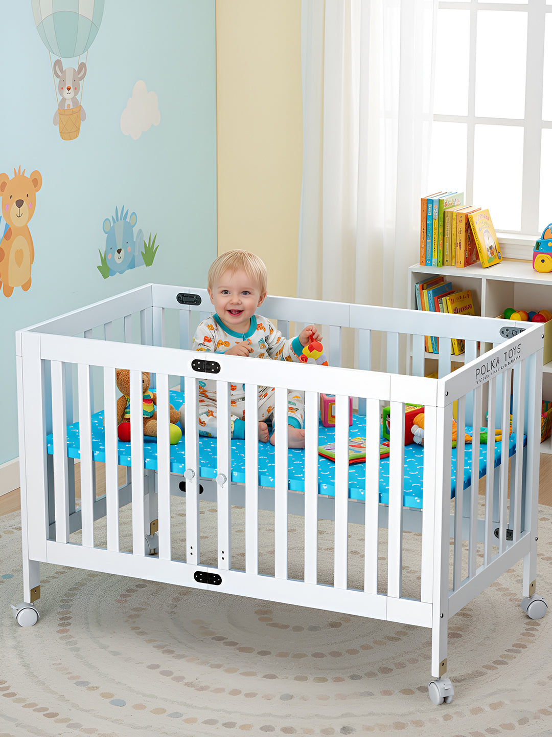 Child in a white crib with colorful bedding in a nursery