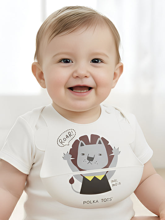 Baby wearing a white onesie with a lion design and 'Polka Tots' branding.