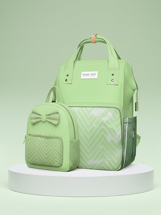 Light green backpack with bow detail on a light green background