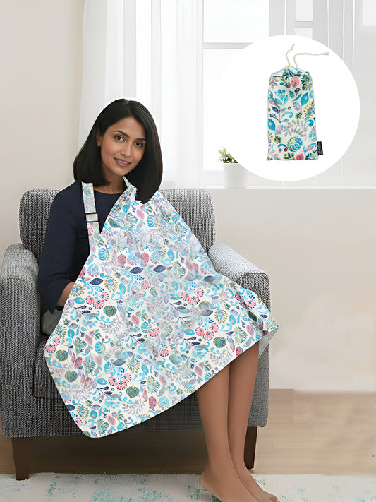 Woman sitting on a chair wearing a floral apron with a matching bag inset.