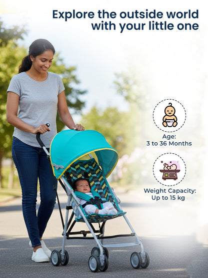 Woman pushing a turquoise stroller with a baby inside, walking outdoors.