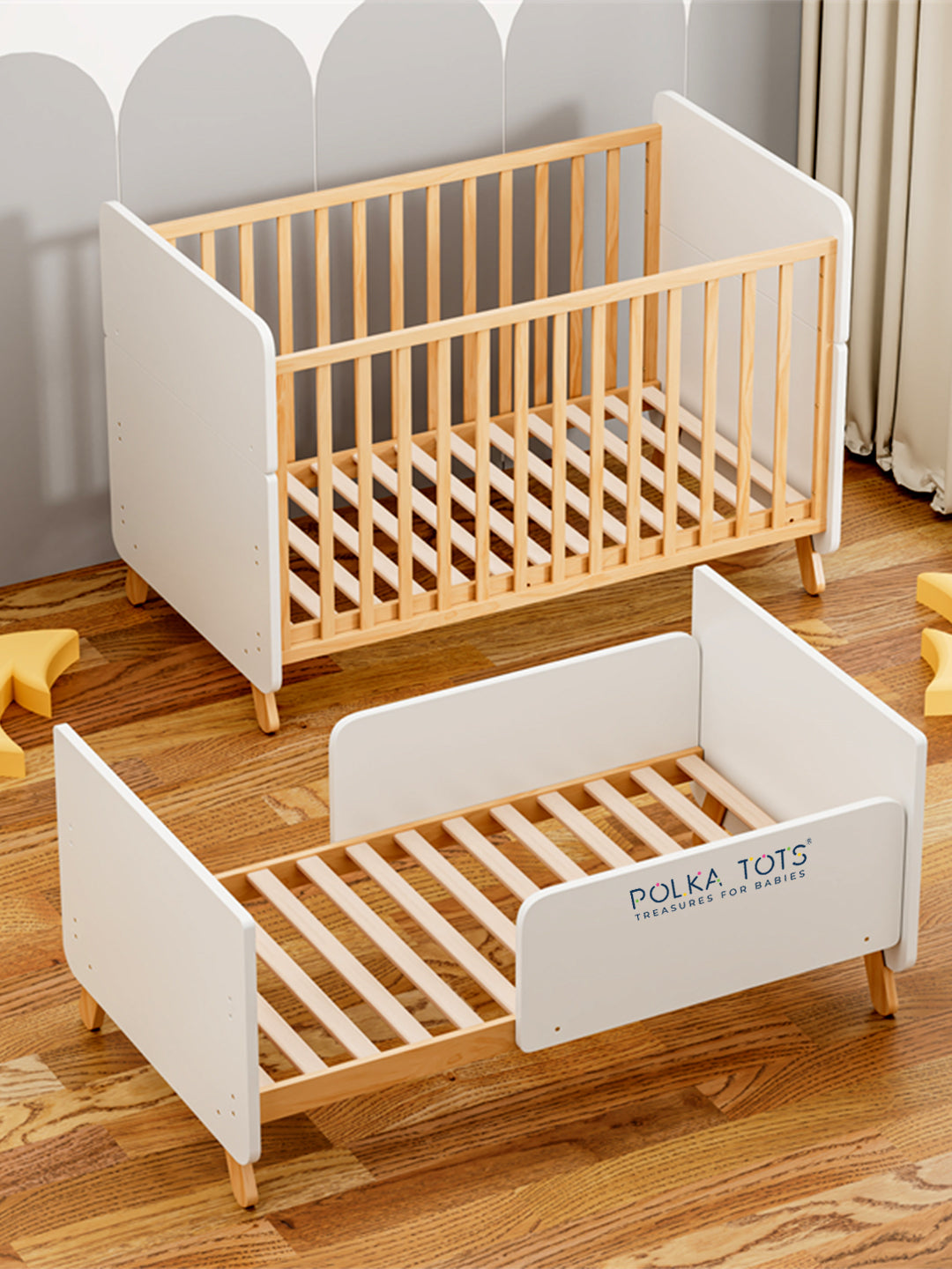 Two wooden children's beds with white frames on a wooden floor.