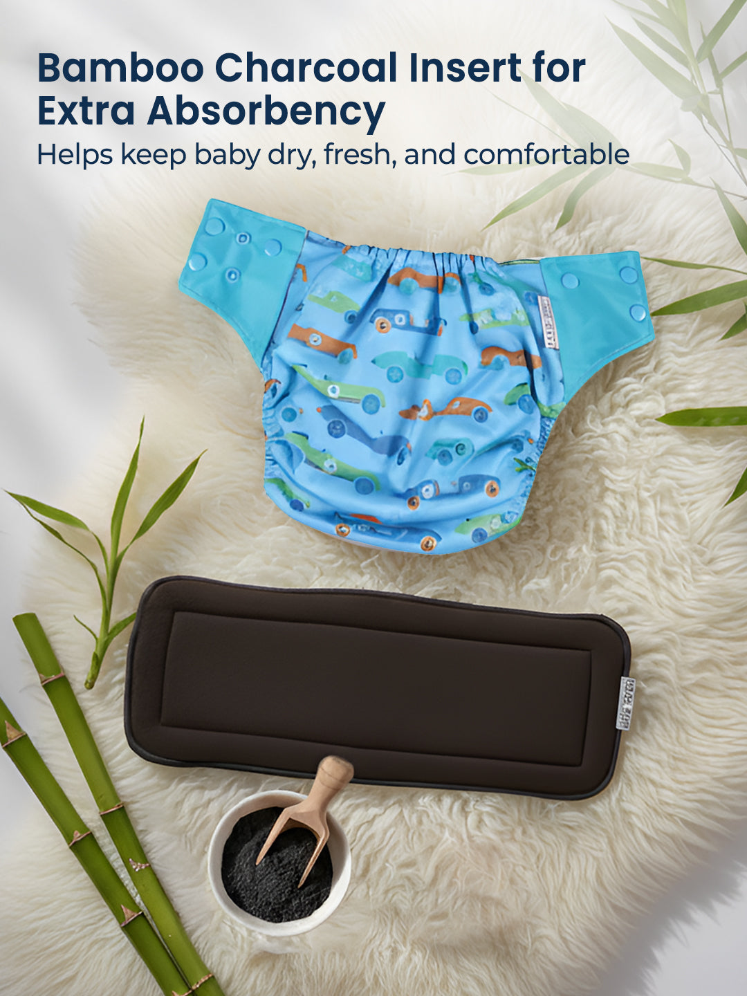 Blue baby diaper with cartoon design on a white surface with bamboo elements.