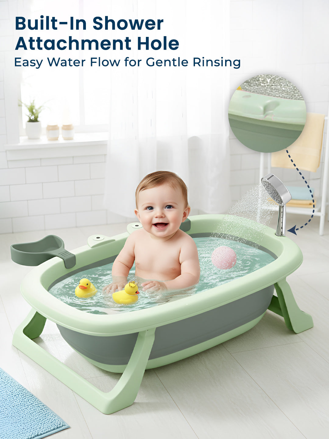 Baby in a green baby bath tub with a built-in shower attachment hole, smiling in a bathroom setting.