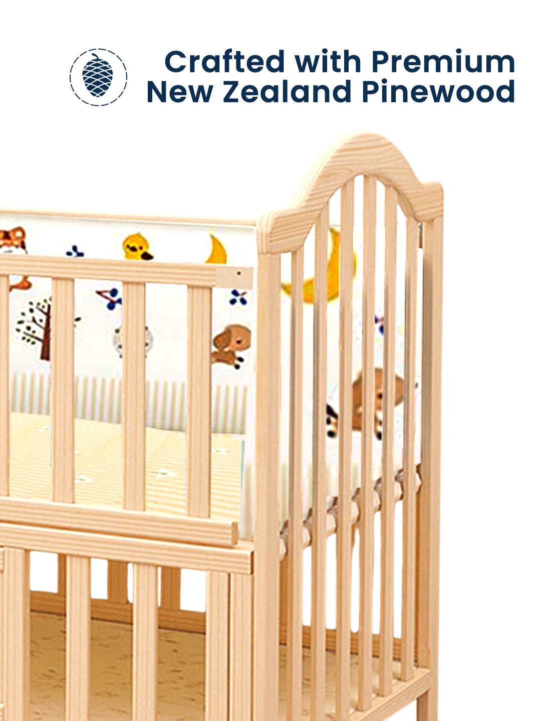 Wooden crib with colorful baby toys on a white background, featuring text about premium New Zealand pinewood.