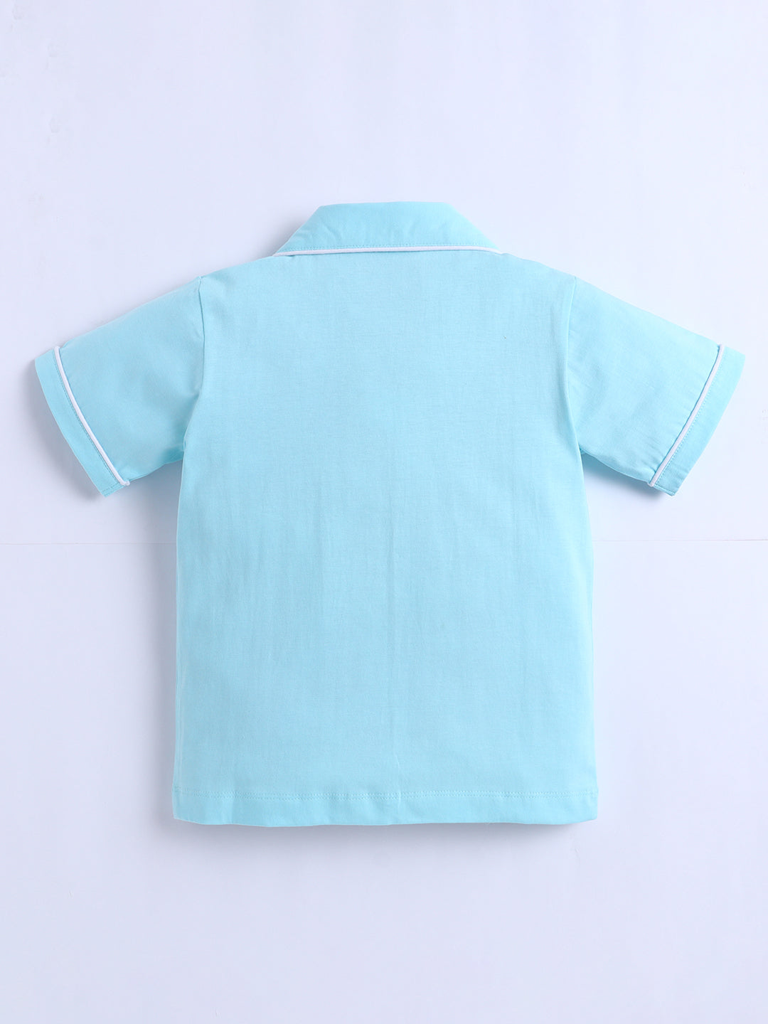 Light blue polo shirt on a light purple background