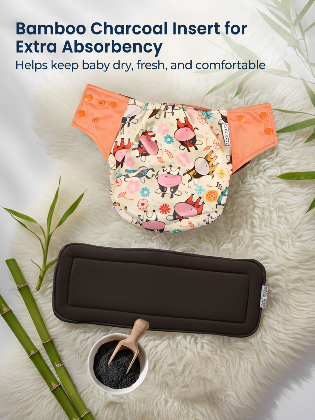 Baby diaper with bamboo charcoal insert on a textured surface with bamboo elements.