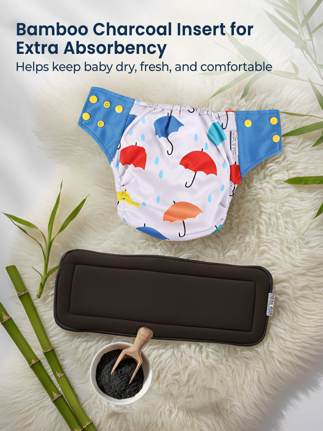 Baby diaper with colorful umbrella pattern and bamboo charcoal insert on a textured surface.