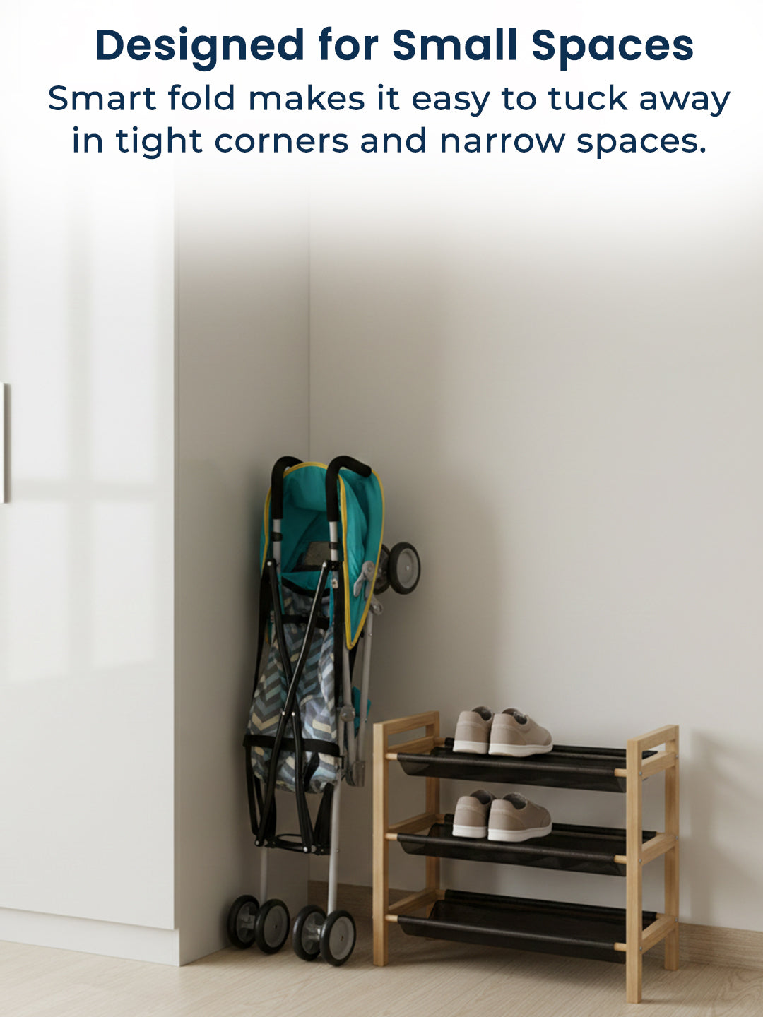 Teal stroller folded and stored on a wooden shoe rack against a white wall.