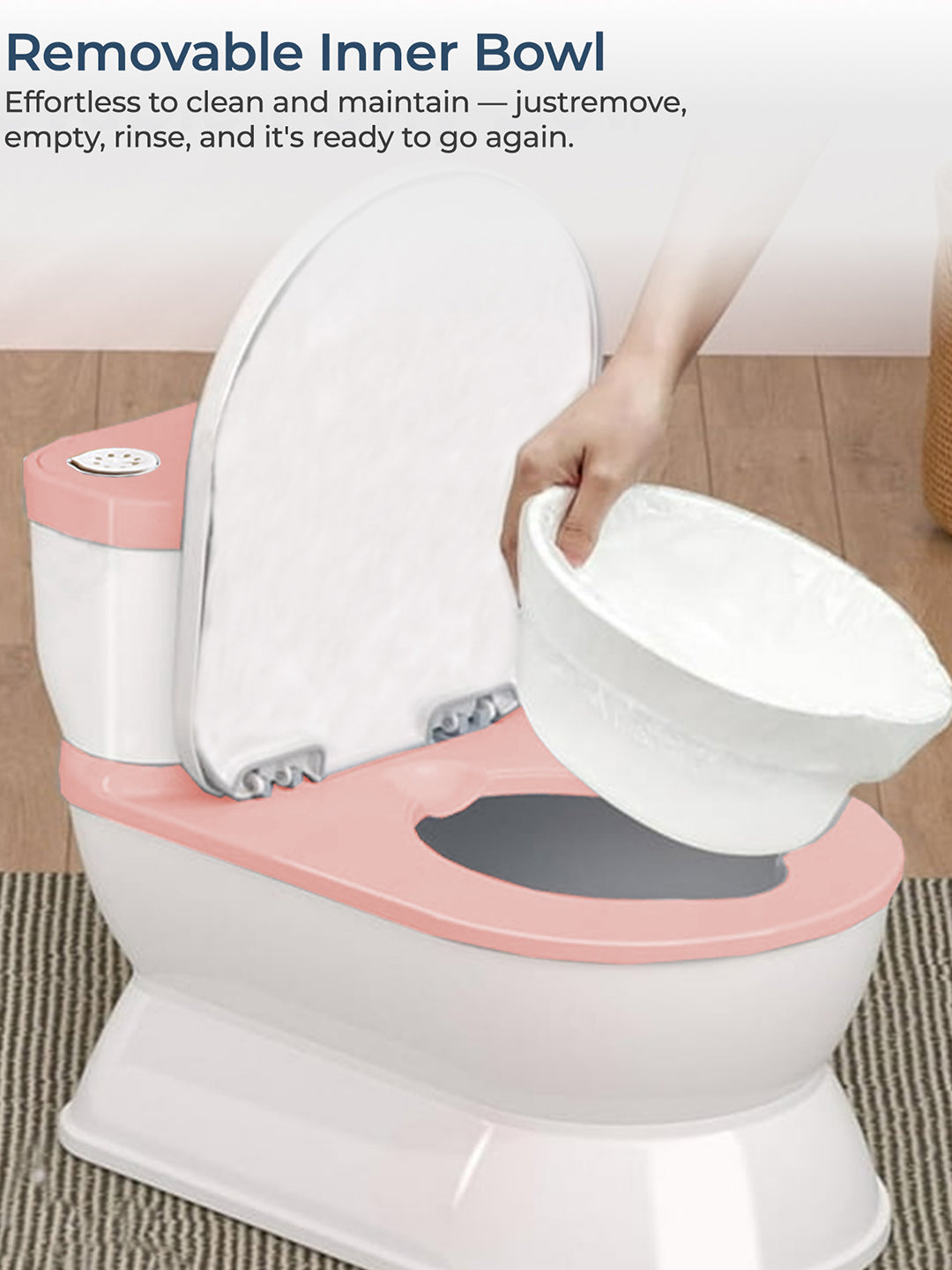 Pink and white toilet seat with a detachable inner bowl being held by a hand.