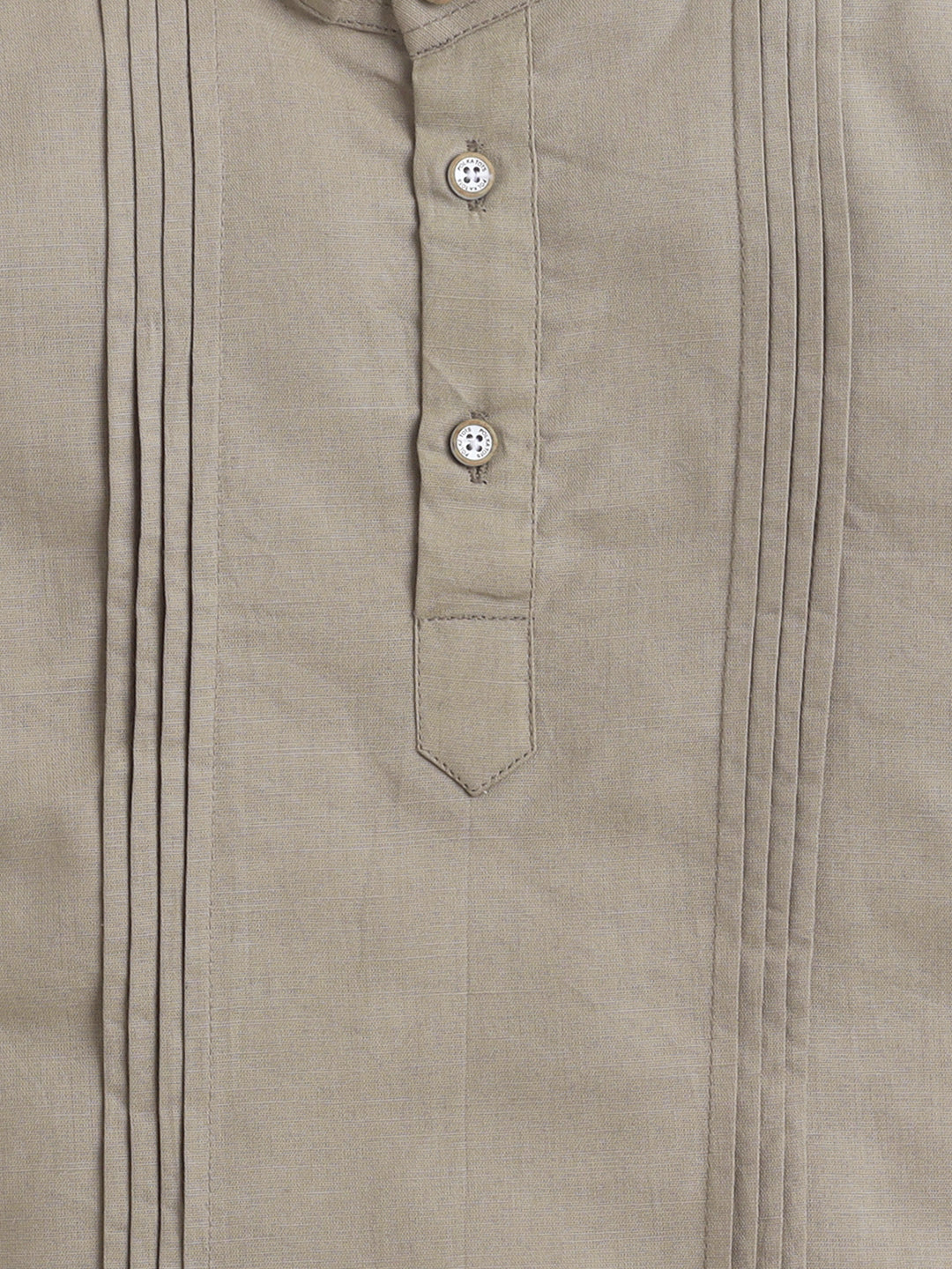 Close-up of a beige shirt with button details