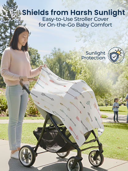 Woman using a stroller with a sunshade cover in a park setting, emphasizing sunlight protection.