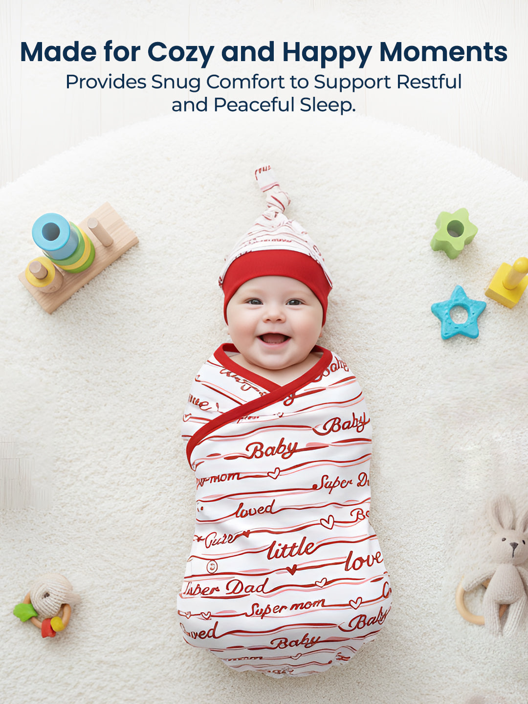 Baby swaddled in a red and white blanket with text, surrounded by toys on a white background.
