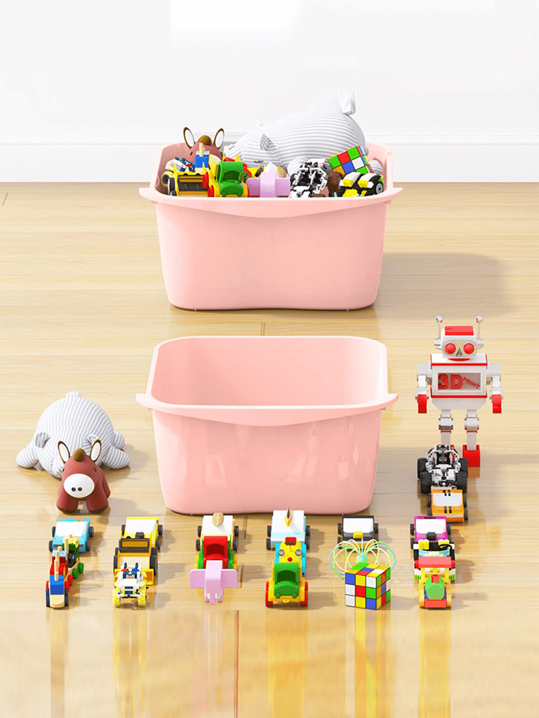 Pink storage baskets with toys on a wooden floor