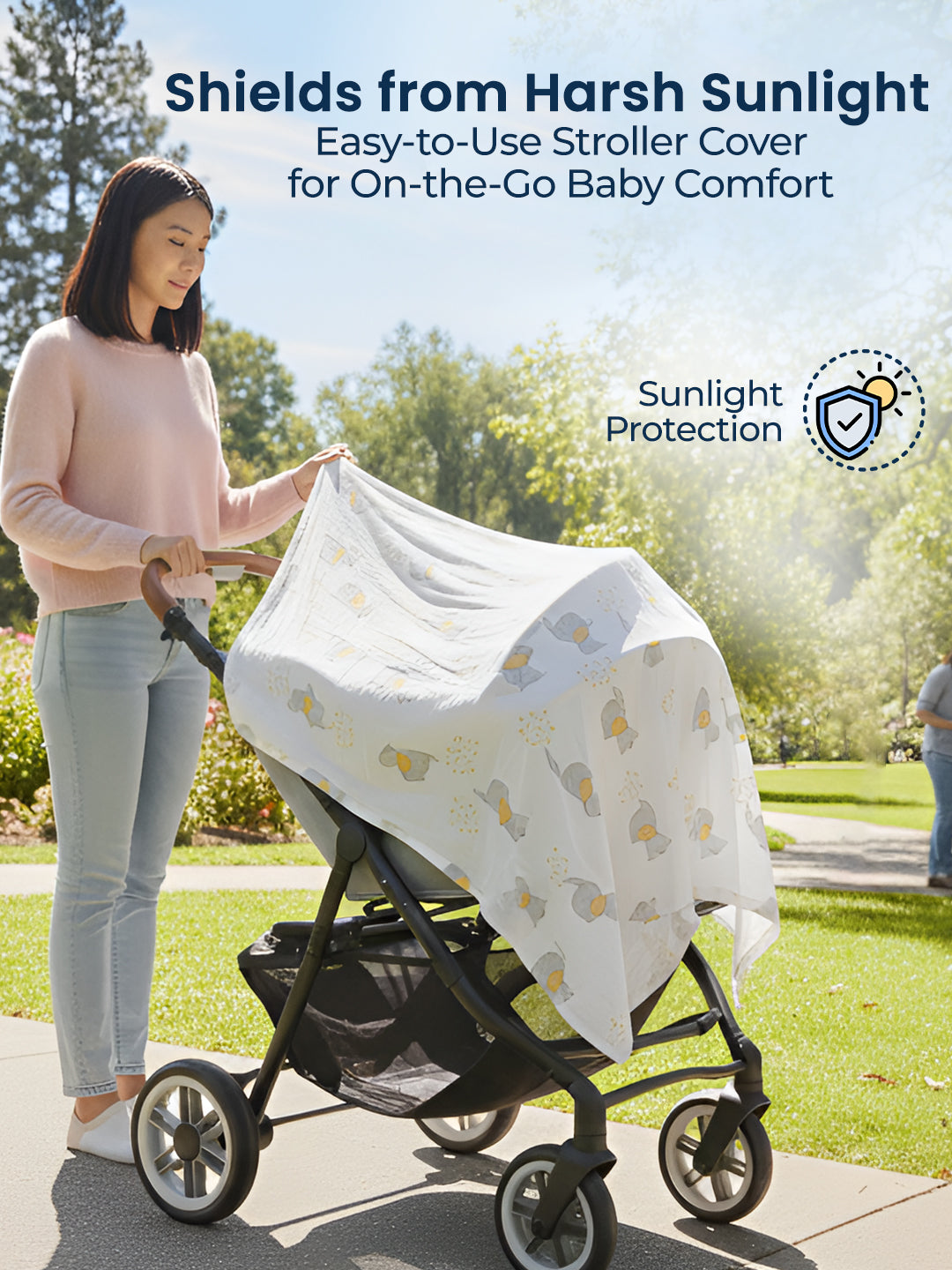 Woman using a stroller cover to shield a baby from harsh sunlight in a park.