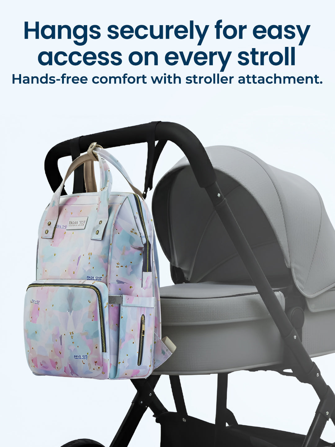 Diaper bag attached to a stroller with text highlighting secure attachment and hands-free comfort.