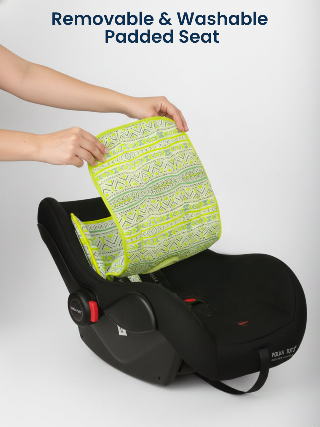 Car seat with a removable and washable padded cover being attached by a person.