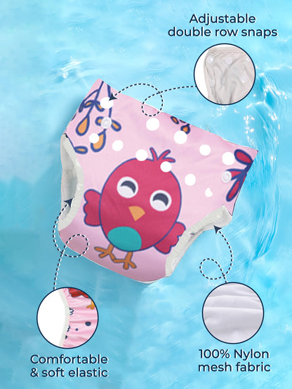 Pink swim cap with owl design on a blue water background