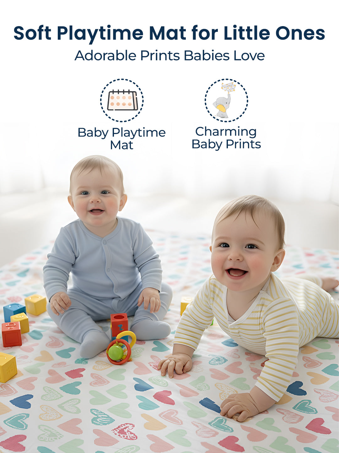 Two babies playing on a soft playtime mat with heart patterns and colorful toys.
