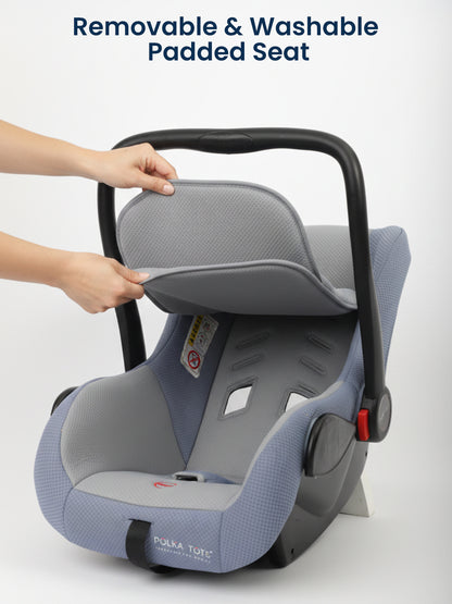 Child car seat with a removable and washable padded seat cover, featuring the Polka Tot brand.
