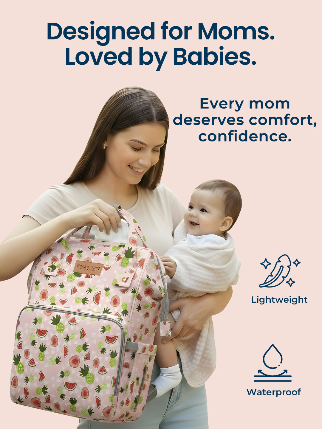Woman holding a baby and a patterned backpack with text 'Designed for Moms. Loved by Babies.' on a light pink background.
