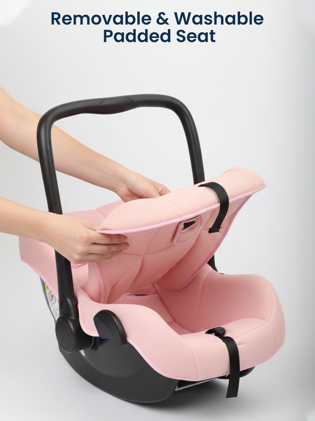 Pink car seat with a black frame, showing a removable and washable padded seat feature.