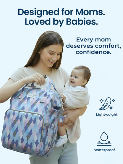 Woman holding a baby and a patterned bag with text 'Designed for Moms. Loved by Babies.' on a light blue background.